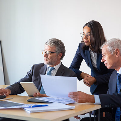 concentrated-partners-using-laptop-working-with-documents-confident-serious-businesspeople-office-suits-discussing-company-project-together-management-business-partnership-concept